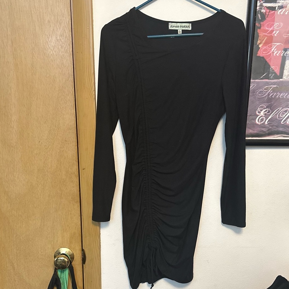 Black long sleeve fitted dress.